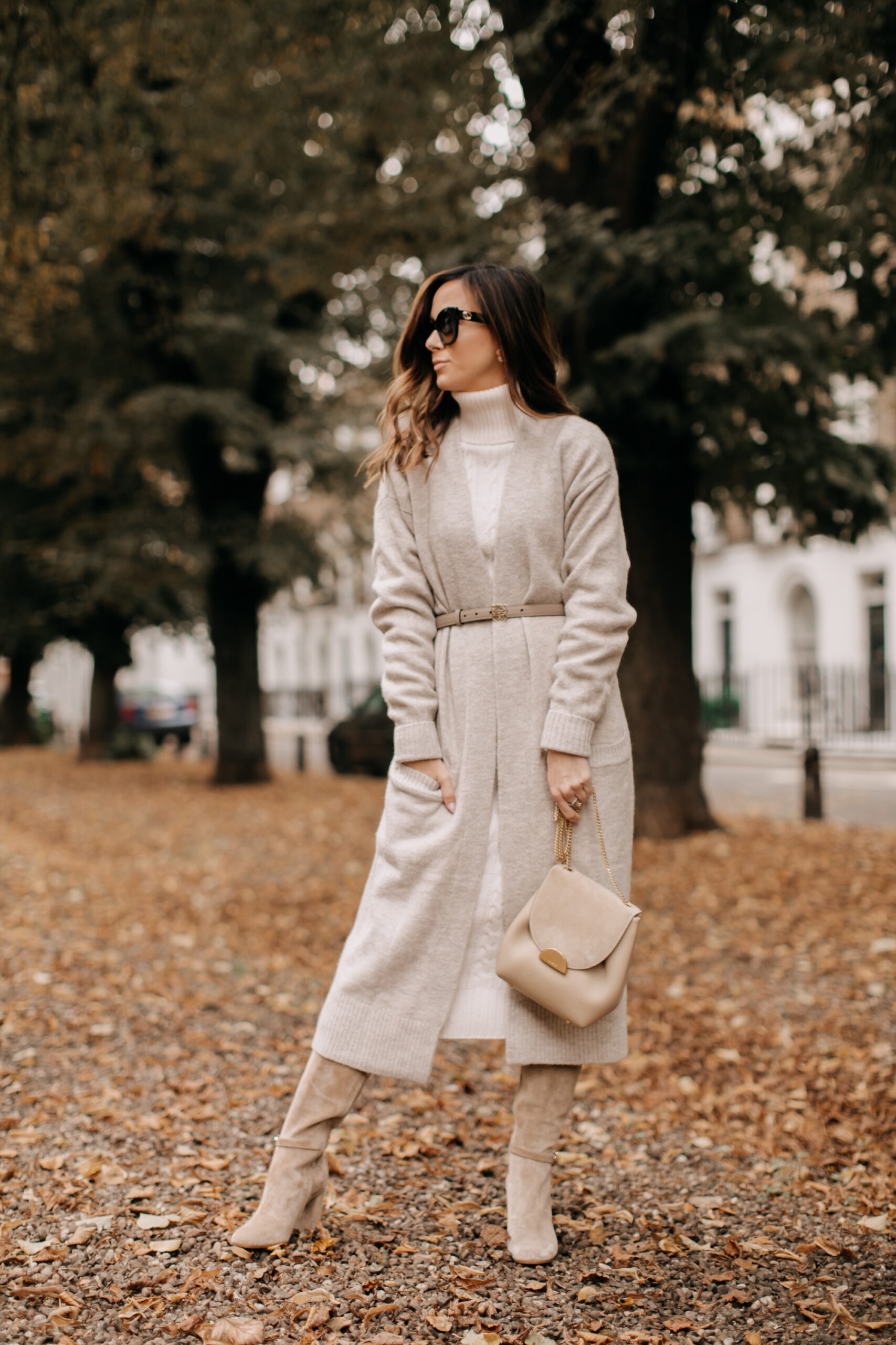 cable knit sweater with a cardigan and suede knee-high boots